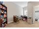 Functional office space with a built-in bookcase and a view of the en-suite bathroom at 219 Mccord St, Charlotte, NC 28216