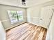 Bedroom featuring a window, wood-look flooring, and modern lighting at 2242 Shumard Cir, Indian Trail, NC 28079
