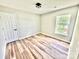 Bedroom with light walls, wood-look floors, a window, and a door at 2242 Shumard Cir, Indian Trail, NC 28079