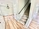 Bright entryway with light wood flooring, staircase with carpeted steps, and elegant light fixture at 2242 Shumard Cir, Indian Trail, NC 28079