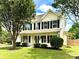 Charming two-story home with manicured lawn, lush landscaping, and welcoming front porch at 2242 Shumard Cir, Indian Trail, NC 28079