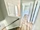 Upstairs hallway with light wood flooring and access to multiple rooms at 2242 Shumard Cir, Indian Trail, NC 28079
