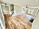 Open-concept living room features light wood flooring, fireplace, modern lighting, and lots of natural light at 2242 Shumard Cir, Indian Trail, NC 28079