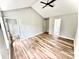 Spacious main bedroom boasts vaulted ceiling, light wood floors, and ensuite bathroom and walk-in closet at 2242 Shumard Cir, Indian Trail, NC 28079
