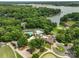 Stunning aerial view of the club house, pool, golf course, and lake in a lush, green, gated community at 23 Tanglewood Rd, Clover, SC 29710