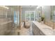 Bright bathroom with a glass shower, separate soaking tub, double vanity, and natural light at 23 Tanglewood Rd, Clover, SC 29710