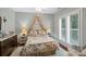 Charming bedroom with floral bedding, canopy, shuttered windows, and cozy white rug at 23 Tanglewood Rd, Clover, SC 29710