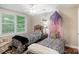 Stylish bedroom featuring twin beds with zebra-print bedding and window views to the outside at 23 Tanglewood Rd, Clover, SC 29710
