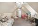 Spacious bonus room with sloped ceilings, cozy seating, and a play area with a dollhouse at 23 Tanglewood Rd, Clover, SC 29710