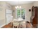 Sunlit dining area features a white table, chairs, chandelier, and french doors to the exterior at 23 Tanglewood Rd, Clover, SC 29710
