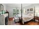 Comfortable primary bedroom with a four-poster bed, fireplace, bench, and serene decor at 23 Tanglewood Rd, Clover, SC 29710