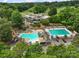 Gorgeous aerial shot of the neighborhood pool, including multiple seating areas and mature green trees at 23 Tanglewood Rd, Clover, SC 29710
