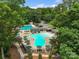 Beautiful pool surrounded by lounge chairs, green umbrellas, mature trees, and parking at 23 Tanglewood Rd, Clover, SC 29710