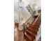 Elegant staircase featuring wood steps, black iron railings, and beautiful hardwood floors at 23 Tanglewood Rd, Clover, SC 29710
