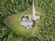 An aerial view of the house, showcasing its wooded surroundings and private driveway at 237 Garvin Rd, McConnells, SC 29726