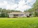 Large lawn, trees, porch, and patio create a peaceful outdoor living space at 237 Garvin Rd, McConnells, SC 29726