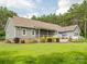 The home's backyard shows a spacious lawn, screen porch, and deck with a white railing fence at 237 Garvin Rd, McConnells, SC 29726