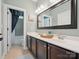 Bathroom featuring double sinks with white countertops, dark wood cabinetry, and a shower/tub combo at 237 Garvin Rd, McConnells, SC 29726