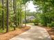 Secluded residence nestled among mature trees, showcasing a sprawling driveway and verdant landscaping at 237 Garvin Rd, McConnells, SC 29726
