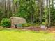 Beautiful greenhouse and garden beds nestled among lush greenery, perfect for gardening enthusiasts at 237 Garvin Rd, McConnells, SC 29726