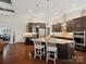 Bright kitchen showcasing dark cabinets, stainless steel appliances, granite counters, and a convenient center island at 237 Garvin Rd, McConnells, SC 29726