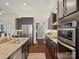Modern kitchen showcasing sleek, dark cabinets, stainless steel appliances, and stylish granite countertops at 237 Garvin Rd, McConnells, SC 29726