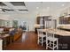 Open-concept kitchen with dark cabinets, granite island, and a seamless transition to the living and dining spaces at 237 Garvin Rd, McConnells, SC 29726