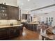 Modern kitchen with dark cabinets, granite countertops, stainless steel appliances, and an open dining area at 237 Garvin Rd, McConnells, SC 29726