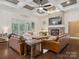 Spacious living room featuring a coffered ceiling, stone fireplace, and access to an outdoor patio at 237 Garvin Rd, McConnells, SC 29726