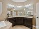 Bright main bathroom featuring soaking tub, glass enclosed shower, double vanity with granite countertops and tile flooring at 237 Garvin Rd, McConnells, SC 29726