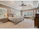 Spacious main bedroom with vaulted ceilings, fan, sitting area, plantation shutters and neutral carpet at 237 Garvin Rd, McConnells, SC 29726