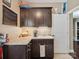 Mudroom features granite countertops, dark cabinetry, sink and faucet, coffee maker, tile flooring and white door at 237 Garvin Rd, McConnells, SC 29726