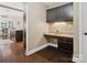 Functional office nook with dark cabinetry, granite countertop, and built-in storage, adjacent to the kitchen at 237 Garvin Rd, McConnells, SC 29726