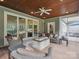 Covered back patio with a stone fire pit, ceiling fan, and comfortable seating arrangements at 237 Garvin Rd, McConnells, SC 29726