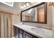 Well-lit bathroom features a double sink vanity and a large framed mirror at 25056 Timberlake Dr, Fort Mill, SC 29708