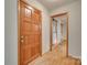 Inviting entryway with a solid wood door and beautiful hardwood floors at 25056 Timberlake Dr, Fort Mill, SC 29708
