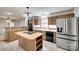 Open kitchen with stainless steel appliances, a center island, and ample cabinet space at 25056 Timberlake Dr, Fort Mill, SC 29708
