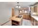 Kitchen with wooden island cooktop, tile floor, and wooden cabinets at 25056 Timberlake Dr, Fort Mill, SC 29708
