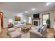 Bright living room featuring a fireplace, wood floors, and comfortable seating at 25056 Timberlake Dr, Fort Mill, SC 29708