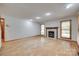 Spacious living room featuring a fireplace, wood floors, and lots of natural light at 25056 Timberlake Dr, Fort Mill, SC 29708