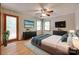 Cozy bedroom with hardwood floors, two TVs, and a door leading to the outside at 25056 Timberlake Dr, Fort Mill, SC 29708