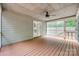 Inviting screened porch with wood flooring, ceiling fan, and views of lush greenery at 25056 Timberlake Dr, Fort Mill, SC 29708