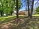 Lush backyard with a large wooden deck surrounded by mature trees at 2600 Alleghany St # 10, Charlotte, NC 28208