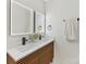 Modern bathroom featuring double sinks with sleek fixtures, stylish vanity, and a pair of lighted mirrors at 2600 Alleghany St # 10, Charlotte, NC 28208
