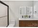 Modern bathroom featuring double sinks with sleek fixtures, stylish vanity, and a glass-enclosed shower at 2600 Alleghany St # 10, Charlotte, NC 28208