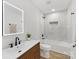 Modern bathroom featuring white marble shower, wood vanity, and tiled floors at 2600 Alleghany St # 10, Charlotte, NC 28208