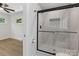 Modern bathroom featuring a glass enclosed tiled shower adjacent to the bedroom at 2600 Alleghany St # 10, Charlotte, NC 28208