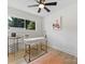 Stylishly decorated bedroom features wood-look flooring and a modern ceiling fan at 2600 Alleghany St # 10, Charlotte, NC 28208