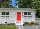 Charming home featuring a bright red door, brick exterior, and well-manicured landscaping at 2600 Alleghany St # 10, Charlotte, NC 28208