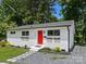 Charming home featuring a bright red door, brick exterior, and well-manicured landscaping at 2600 Alleghany St # 10, Charlotte, NC 28208